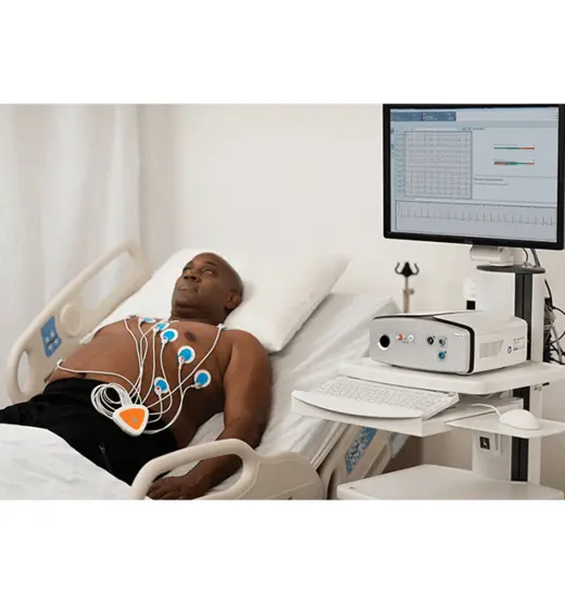 Patient wearing the Vyntus 12-lead device while being tested resting in bed.