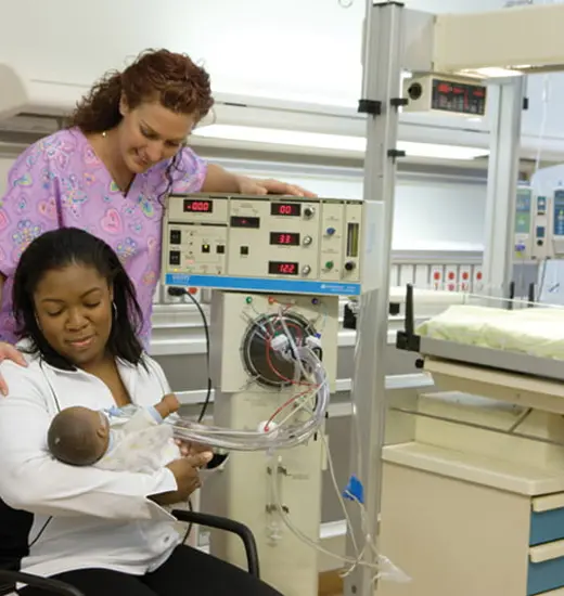 A respiratory therapist working with a patient in a clinical setting