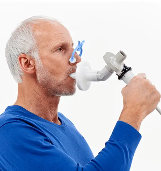 Patient breathing into Vyaire's Vyntus SPIRO PC Spirometer pulmonary function testing device.