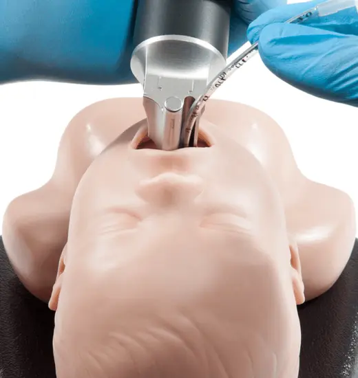 InfantView video laryngoscope being used on a life sized practice model.